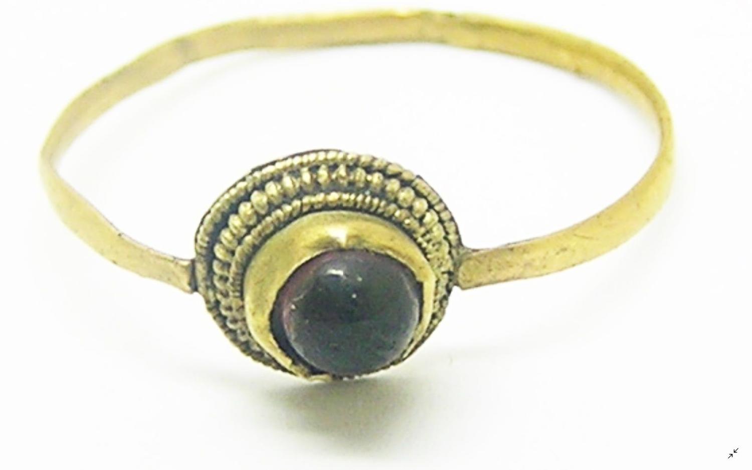 Medieval gold penny ring set with garnet gemstone