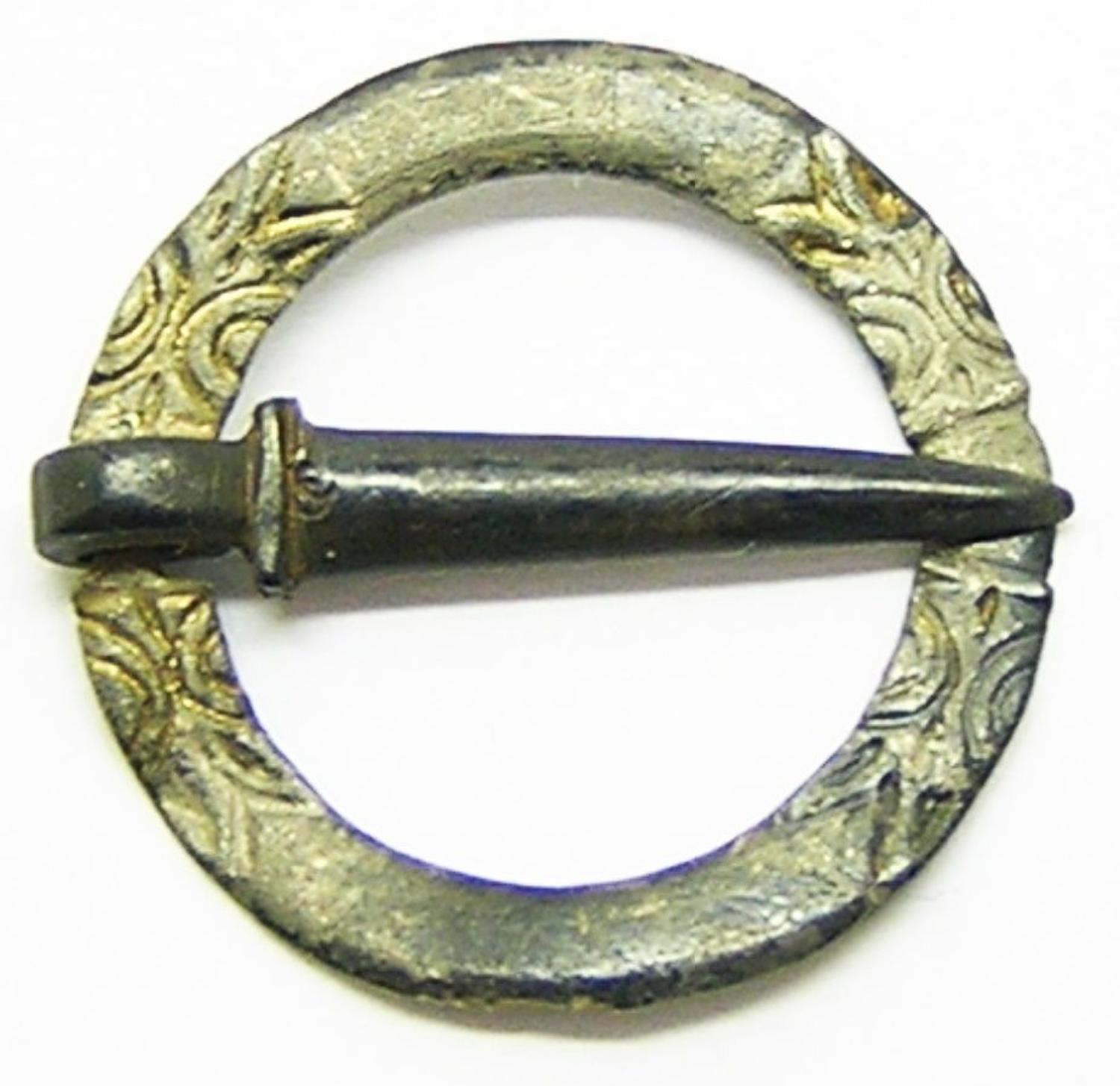 Medieval silver gilt ring brooch with biting beasts